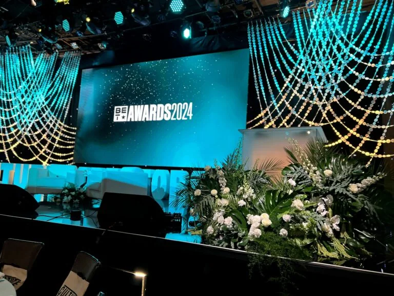 Wide BET Awards stage view with architectural white and green floral installations