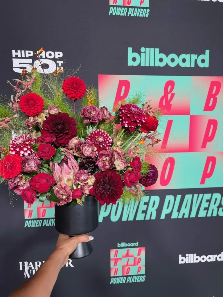 Deep red and burgundy floral arrangement photographed at a Billboard event